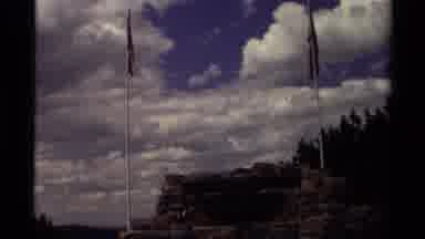 Canada (1979): Flagpoles In Front Of A Clouded Sky And A Mountain In The Distance