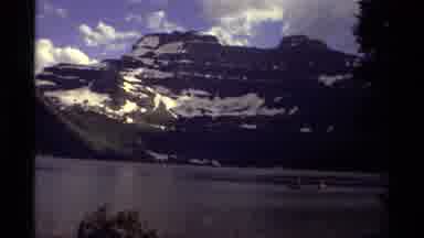 Canada (1979): People Riding In Little Boats In The Ocean With A Background View