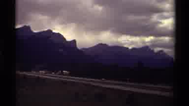 Canada (1979): Camera Looks At Sign And Then A Highway That Sits Off A Mountain