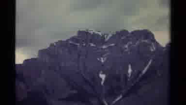Canada (1979): Closeup Of Rocky Mountain Peak With Snow Zooming Out Showing All Of