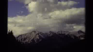 Canada (1979): Partially Cloudy Blue Sky Hovering Over Snow Covered Mountains