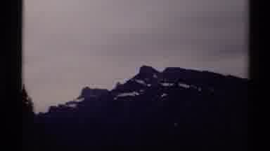 Canada (1979): Snow Covered Mountains In The Distance With Gray Sky In The