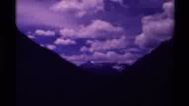 Canada (1979): Retro Footage View Between Mountains Showing A Clean Sky With