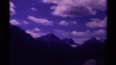 Canada (1979): Panning Video Of Snow Capped Mountains With Sky Background With
