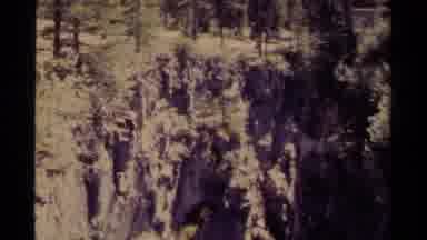 Canada (1979): Hikers Walk Pass A Huge Cliff On The Mountain Top