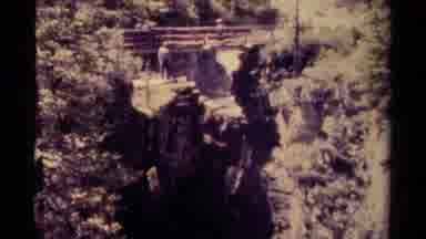 Canada-1979: Man Viewing Bridge Over Waterfall Retreats Back Up Cliff