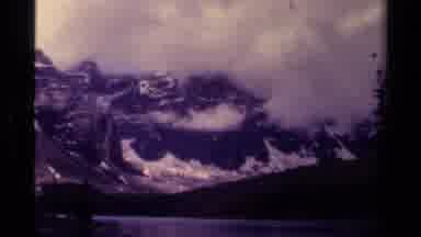 Canada (1979): A Cloudy Misty Mountain Range Flanked By A Lake