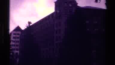 Canada (1979): A Large Building Surrounded By Pine Trees And A Body Of Water