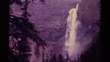 Canada (1979): A Forested And Mountainous Region With A Roaring Waterfall In The