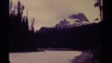 Canada (1979): Body Of Water At The Foot Of A Large Cloudy Mountain With A Sign