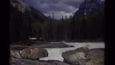 Canada (1979): A View Of Humongous Rocks Surrounded By Water And Mountain Peaks