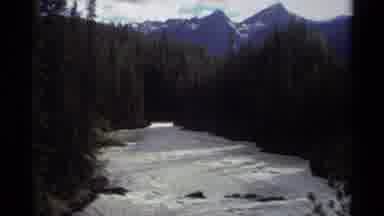 Canada (1979): View Of A River Between High Trees And Mountains In The Distance