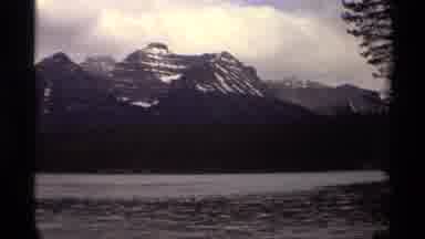 Canada (1979): Sun Shining Through Clouds On A Placid Lake Surrounding A Beautiful