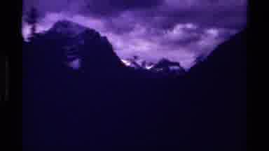 Canada (1979): Old Camera Purple Zoom On Snowy Mountains With Cloudy Weather