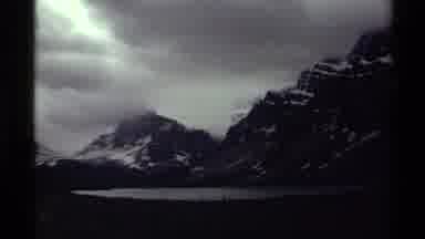 Canada (1979): Snowy Mountains Above A Lake Under Dramatic Cloudy Skies