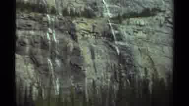 Canada (1979): View Of The Side Of A Rocky High Mountain With Trees On Top And