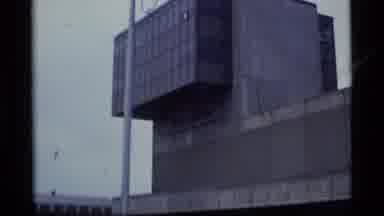 Alaska USA (1977): A Boat Passes By All The Buildings In This Riverside Town