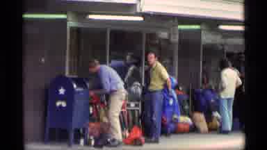 Alaska USA (1977): People Standing Outside Of Busy Airport Terminal And A Small