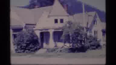 Alaska USA (1977): Buildings Placed On The Flat Ground Before Hills And A Bus