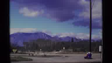 Alaska USA (1977): Wide Shot Of Mountain Tops In The Distance With Trees In Front