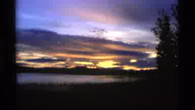 Alaska USA (1977): Rising Sun Beyond The Flowing Clouds Calm Waters Breezy Green