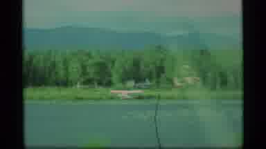 Alaska USA (1977): House Amongst Pine Trees And A Large Mountain With Small Amount