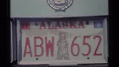 Alaska USA (1977): Close Shot Of Alaska License Plate With Bear On It Then A Shot