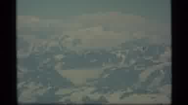 Alaska USA (1977): Flying Over Foggy Snow Capped Mountain Range Shows Off