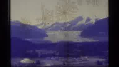 Alaska USA (1977): View Of Large Lake Surrounded By Trees And Snowy Mountains Then