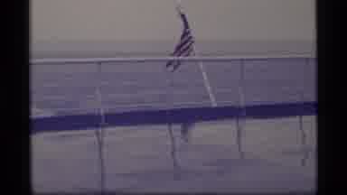 Alaska USA (1977): American Flag Flying From A Ship Cruising The Open Ocean