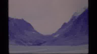 Alaska USA (1977): Shot Of A Pass Between Two Mountain Top With Two People Looking