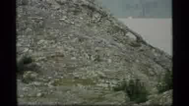 Alaska USA (1977): Two People Are Standing At The Base Of A Small Hill