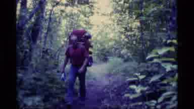 Alaska USA (1977): Two Hikers Wearing Large Backpacks Trek Toward Camera Man In