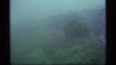 Alaska USA (1977): A Dark Eerie View Of A Mountain Peak And A Dry Green View Of A