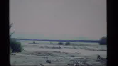 Alaska USA (1977): Zoom Of Mountains Across A Bay Then Zoom Of Boat On Land