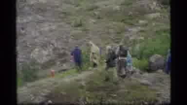 Glacier Bay Alaska USA (1977): People Hiking On Green Rocky Trail On A Clear Day