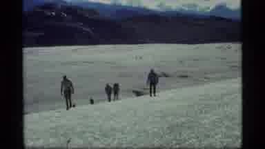 Glacier Bay Alaska USA (1977): People Walking Across Large Meadow With Clouds In