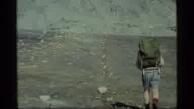 Glacier Bay Alaska USA (1977): Man Backpacking Across Dry Rocky Area Toward