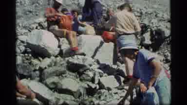 Glacier Bay Alaska USA (1977): People Sitting On Rocks Located Near Some Foliage