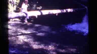 Sapphire Lake Montana USA (1977): Small Caucasian Boy Scouts Along A Pipe Over A