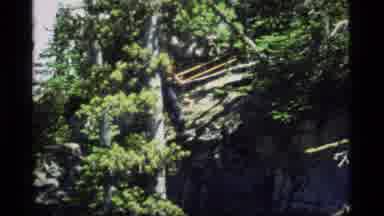 Sapphire Lake Montana USA (1977): Man Cutting Down Tree From Side Of Mountain In