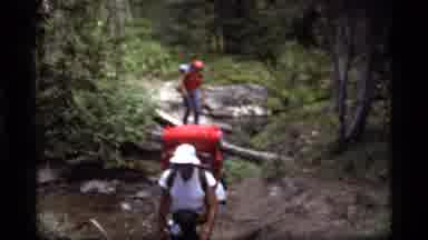 Sapphire Lake Montana USA (1977): Two People Hiking Through A Forest And Crossing