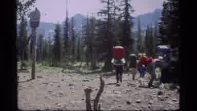 Sapphire Lake Montana USA (1977): Hikers Depart Rocky Clearing In Forest With View