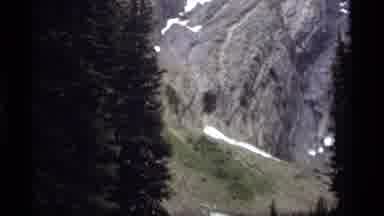 Sapphire Lake Montana USA (1977): Panning Upwards Showing Pine Trees Snow Capped