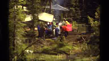 Sapphire Lake Montana USA (1977): A Group Of People In A Forest Gathered Amidst
