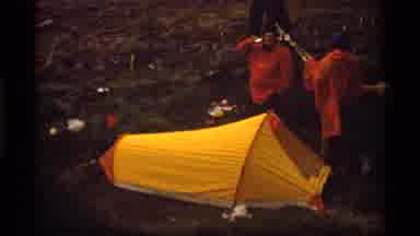 Sapphire Lake Montana USA (1977): Men Wearing Orange Ponchos Camping In A Forest