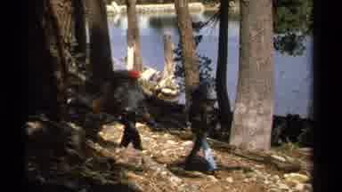 Lake Tahoe California USA (1978): Three Hikers With Backpacks Walk On A Trail Next