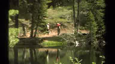 Lake Tahoe California USA (1978): People With Backpacks Hiking Along The Banks Of