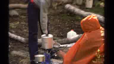 Lake Tahoe California USA-1978: Rough Camping In Cool Weather Boiling Water And Preparing Food