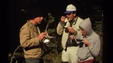 Lake Tahoe California USA (1978): Two Men And One Young Man Stand Around Eating